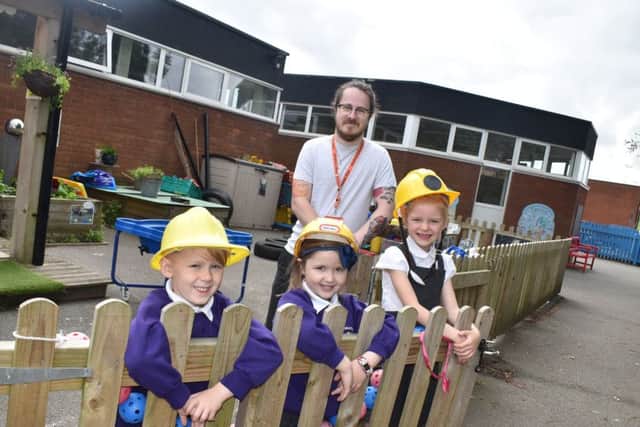 Teacher Sam Snodin, who is also a past pupil, with reception class children at Sherard Primary School in Melton EMN-190619-104649001