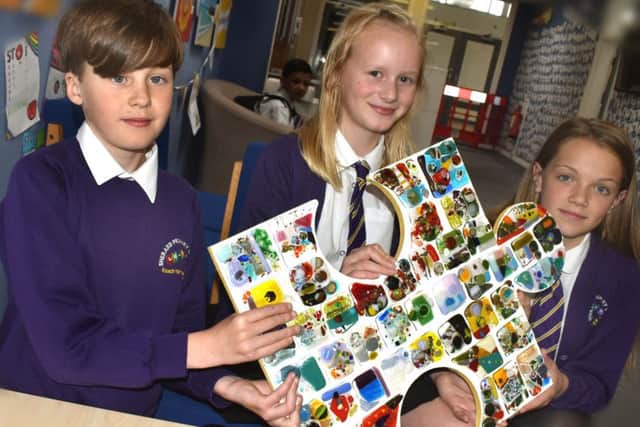 Pupils with a piece of glass anniversary jigsaw the Friends of Sherard School paid for to mark the 50th birthday of the school EMN-190619-104746001