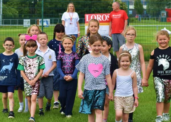 Pupils and staff at Sherard Primary School take part in their fundraising 'Sparkle Walk' in memory of former teacher, Lynda Spargo, who recently passed away EMN-190626-131021001