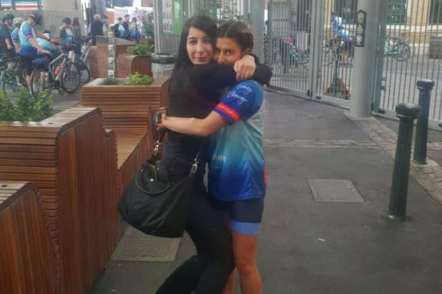 Holly Jones is hugged by Christine Delcros (right), whose partner was killed in the London Bridge terrorist attack, before the cycling fundraisers set off for Paris EMN-190628-102824001