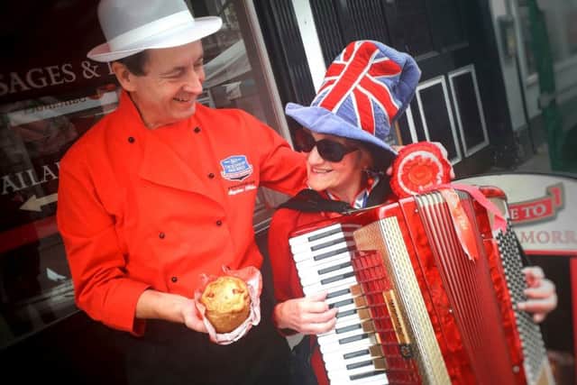 Stephen Hallam, managing director at Dickinson and Morris, is serenaded by street entertainer Rosemary Wright EMN-190107-175909001