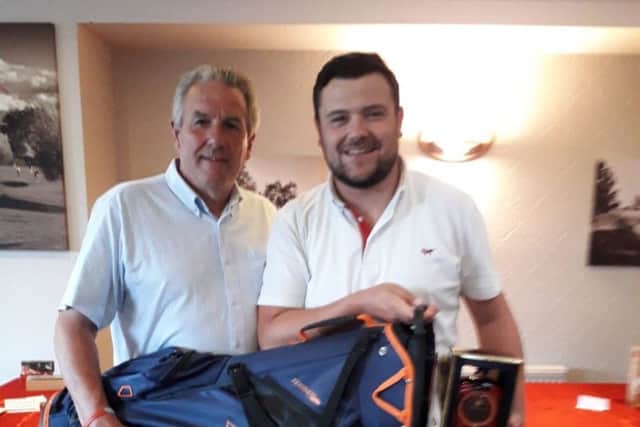Club Captain Gerry Stephens, left, presents Danny Raven with his Captain's Day prize.