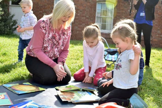 Manager Nikki Clark plays with pre-school children in the garden of Scalford Methodist Church, where the group has met for more than 40 years EMN-191207-161459001