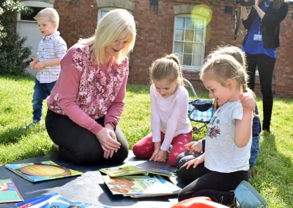 Manager Nikki Clark plays with pre-school children in the garden of Scalford Methodist Church, where the group has met for more than 40 years EMN-191207-161459001