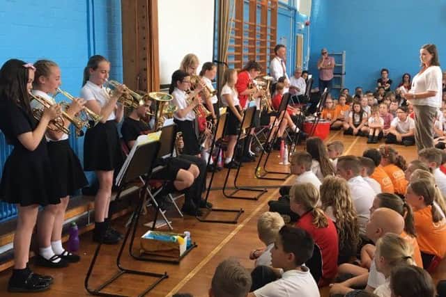 Pupils and staff at Melton's Brownlow Primary School pictured during a special assembly in memory of beloved former teacher Fred Parker, who passed away earlier this year EMN-190715-120011001