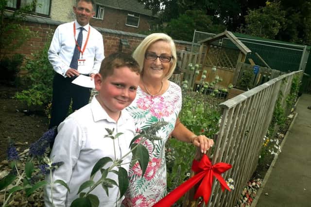 Rosina Rogers and Finlay Billingsley prepare to officially open Brownlow Primary School's new sensory garden with head Damien Turrell EMN-190715-144724001