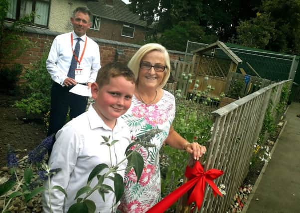 Rosina Rogers and Finlay Billingsley prepare to officially open Brownlow Primary School's new sensory garden with head Damien Turrell EMN-190715-144724001