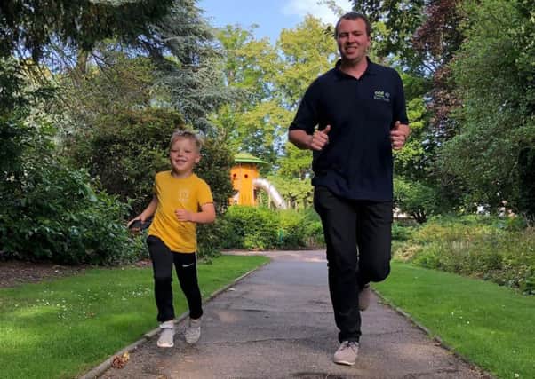Rob Peet and son Christopher (5) run one of their golden miles for LOROS EMN-190715-153037001