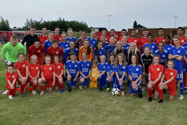 Melton Town and Leicester City Women pose for a mixed team picture before their landmark match EMN-190717-141147002