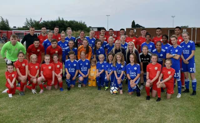 Melton Town and Leicester City Women pose for a mixed team picture before their landmark match EMN-190717-141147002