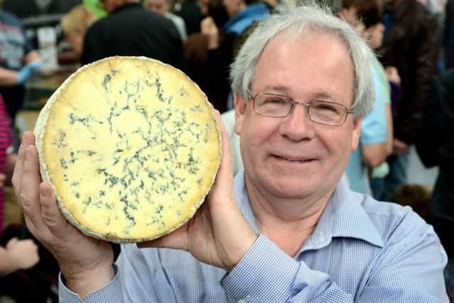 Matthew O'Callaghan, chair of the UK Protected Food Names Association and the Melton Mowbray Food Partnership, holding a drum of Stilton cheese EMN-180926-101005001