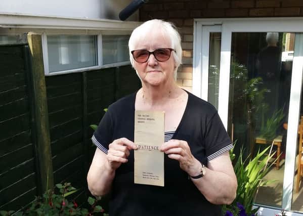 Marilyn Pepper, chair of The Melton Musical Theatre Company, with a programme from the group's first show in 1920 and some photos showing past productions EMN-190724-164558001