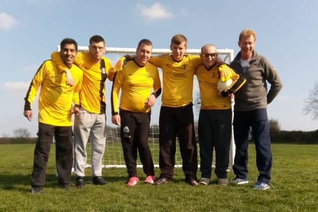 Tommy Williams (far right) with members of the football team he coaches as part of his social care role EMN-190726-164545001
