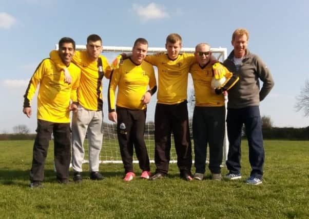 Tommy Williams (far right) with members of the football team he coaches as part of his social care role EMN-190726-164545001