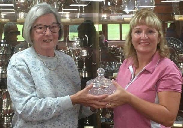 Jo Burroughs presents her crystal trophy to this year's winner Karen Rawson (lady captain) EMN-190309-182039001