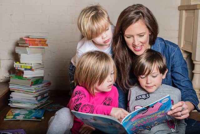 Amanda Overend helps youngsters with their reading.