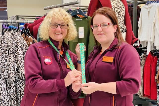 June Dickinson (left) and Hayley Dickson show off the new sunflower lanyards for customers at Sainsburys' store in Melton EMN-190918-094941001