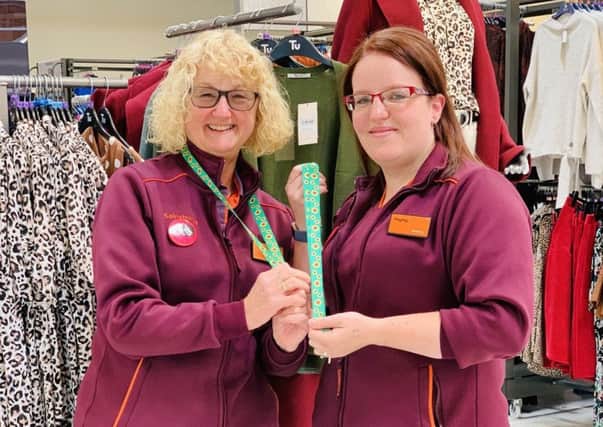 June Dickinson (left) and Hayley Dickson show off the new sunflower lanyards for customers at Sainsburys' store in Melton EMN-190918-094941001