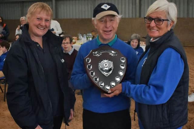 First recipient of the Pat Bishop Volunteer of the Year award, Albert Rutledge, is presented with the shield by county chair Jane Corrall (left), and RDA Mount Group organiser Di Poyzer at a ceremony at their Somerby Equestrian Centre base EMN-190110-122021001