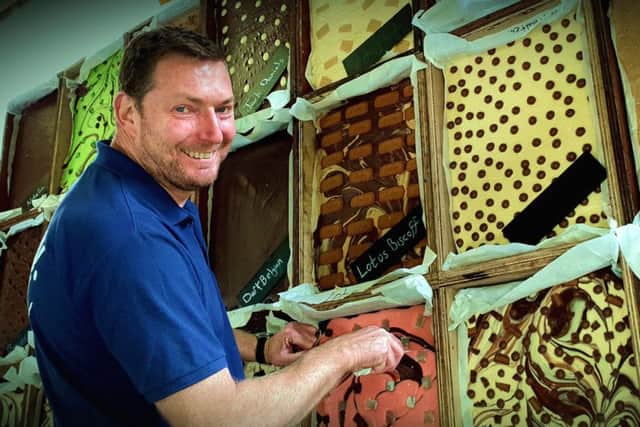 The Chocolate House's Paul Fowler and his tempting chocolate wall PHOTO: Tim Williams