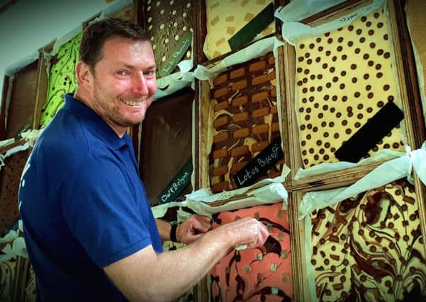 The Chocolate House's Paul Fowler and his tempting chocolate wall PHOTO: Tim Williams