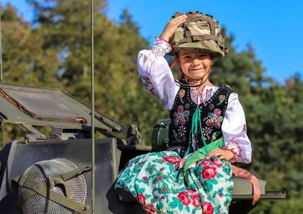 A child from Melton's Polish School climbs aboard a military vehicle after a special service at Saltby Airfield to honour paratroopers from Poland who flew from there to fight in the Second World War EMN-190310-112656001