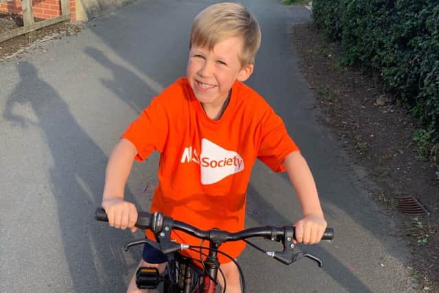 CJ Wood (7) who is taking on a cycling challenge for the MS Society to help sufferers like his dad EMN-190710-130429001