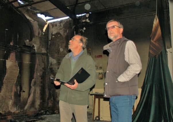Chairman Brian Keevil and treasurer Ian Smith inspect the fire damage at Hose village hall a year ago EMN-190910-162042001