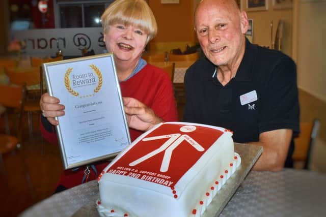 Bob and Jane White with the certificate they received for their work with the Melton prostate cancer support group and a PROSTaid-themed cake members enjoyed at their latest meeting EMN-191010-160309001
