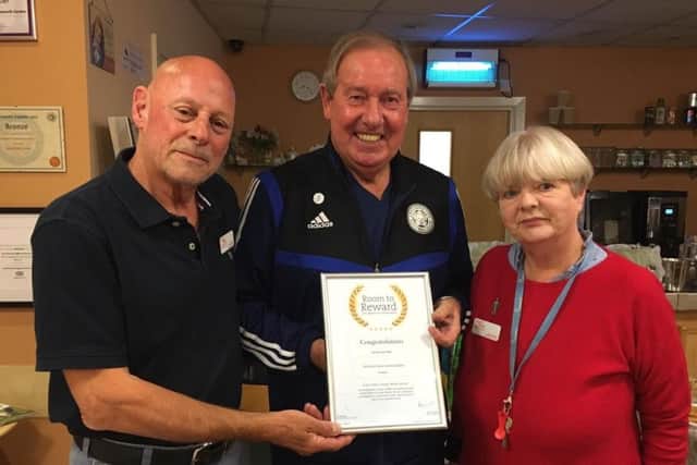 Leicester City FC legend, Alan Birchenall, aka The Birch, presents a certificate to Bob and Jane White for their work with the Melton branch of PROSTaid EMN-191010-160320001