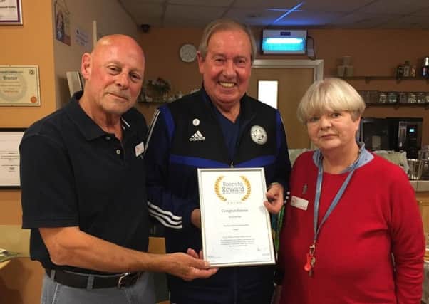 Leicester City FC legend, Alan Birchenall, aka The Birch, presents a certificate to Bob and Jane White for their work with the Melton branch of PROSTaid EMN-191010-160320001