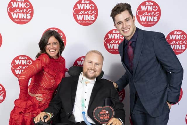 Matt Hampson with his award at The Suns Who Cares Wins Health Awards with presenters Curtis Pritchard and Deborah James EMN-191110-095931001