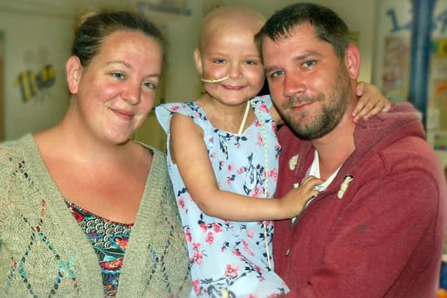Evie Moore pictured, when she was recovering from a bone marrow transplant, with parents Chris and Helena EMN-191021-150542001