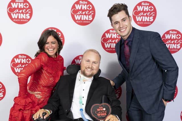 Matt Hampson with his award at The Suns Who Cares Wins Health Awards with presenters Curtis Pritchard and Deborah James EMN-191022-111722001