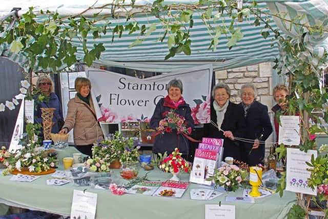 Members of Stamford Flower Club hold a stall on Stamford market on National Flower Arranging Day. EMN-150805-174916001