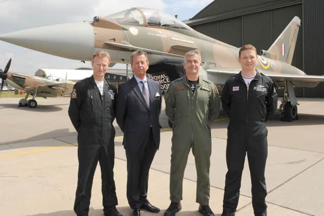 RAF unveils 'Battle of Britain' Tyhoon fighter jet to commemorate the 75th anniversary of Battle of Britain. It was also painted with the 249 squadron ID number of the only Fighter Command pilot awarded with a Victoria Cross, Flight Lieutenant James Brindley Nicolson VC DFC. L-R Flight Lieutenant Antony Parkinson MBE, Jim Nicolson - relative of James Brindley Nicolson, Wing Commander James Heald, and Flight Lieutenant Ben Westoby-Brooks.