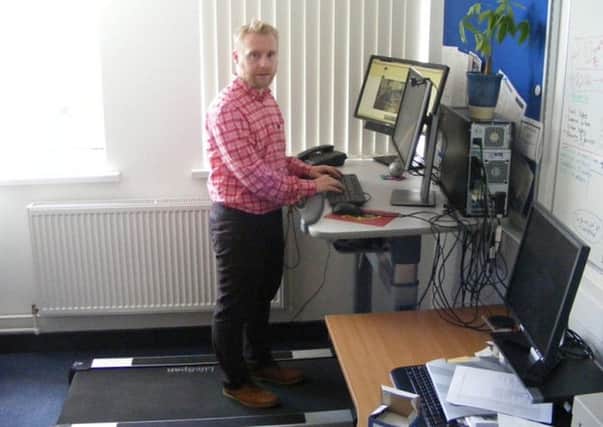 Dr Mark Tully on his treadmill desk at work in Belfasts Queen's University.