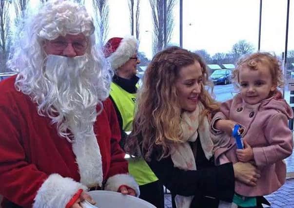 Santa stops off at Melton's Tesco superstore to meet some happy faces PHOTO: Supplied