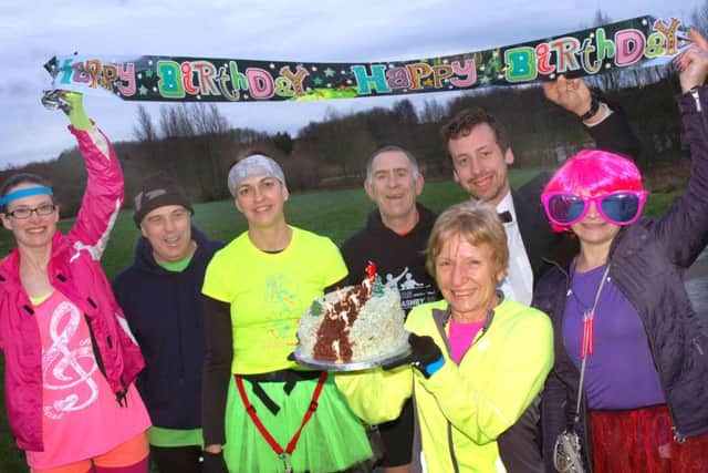 Runners celebrate parkrun's first anniversary in Melton with a birthday cake made by Barbara Hall (front) EMN-160113-113553002