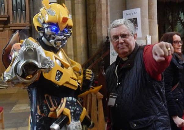 Reverend Kevin Ashby strikes a pose with Bumblebee the Transformer PHOTO: Supplied