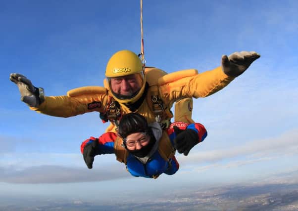 Teresa Phizacklea (53), with her tandem partner for the charity parachute jump which raised around Â£800 for Rainbows Children's Hospice 
PHOTO: Supplied