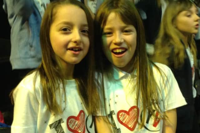 All smiles as the girls show off their Young Voices T-Shirts 
PHOTO: Supplied