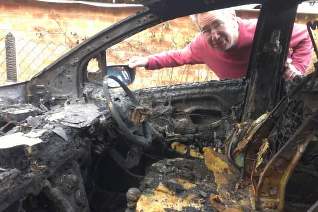 Field Close resident Brian Cunnington inspects the damage to his fire-ravaged car EMN-160202-123000001