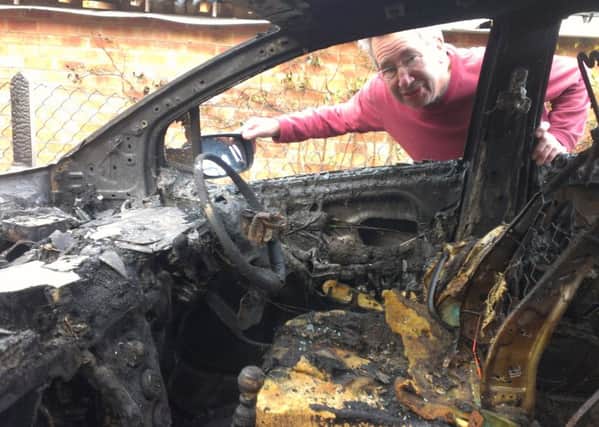 Field Close resident Brian Cunnington inspects the damage to his fire-ravaged car EMN-160202-123000001