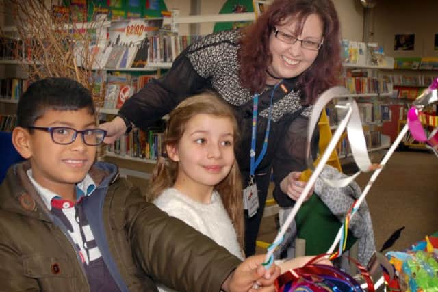 Sidach Jayakody (8) and Maisie Funnel making magic wands with outreach worker Kerry Collings
PHOTO: Tim Williams