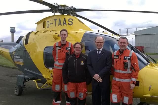 The Melton Building Society chief executive Martin Reason (third from left) with members of the air ambulance crew at their East Midlands Airport base EMN-160802-160844001
