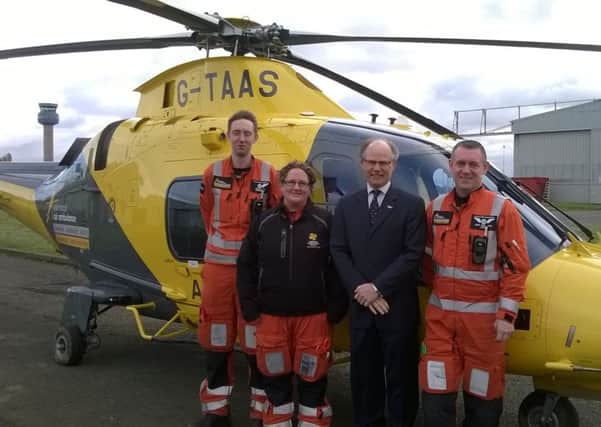 The Melton Building Society chief executive Martin Reason (third from left)  with members of the air ambulance crew at their East Midlands Airport base EMN-160802-160844001
