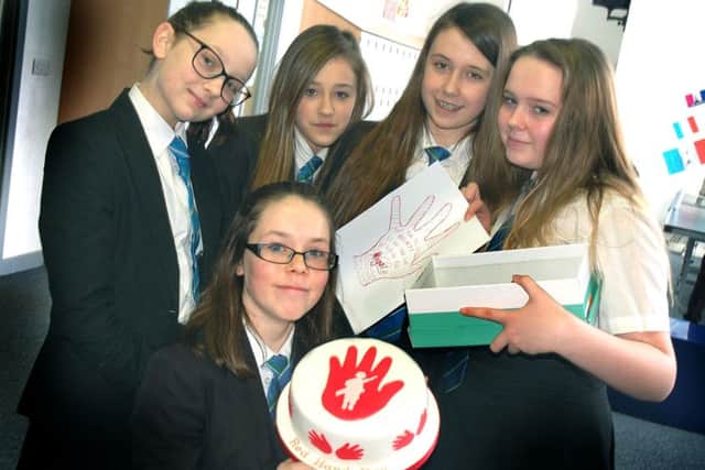 Alicia Riley (front), who brought in a Red Hand cake, with year seven and eight students Abigail Hampson, Courtney Jones, Emma Pickup and Aimee Seymour
PHOTO: Tim Williams