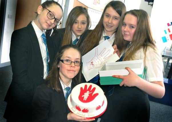 Alicia Riley (front), who brought in a Red Hand cake, with year seven and eight students Abigail Hampson, Courtney Jones, Emma Pickup and Aimee Seymour
PHOTO: Tim Williams
