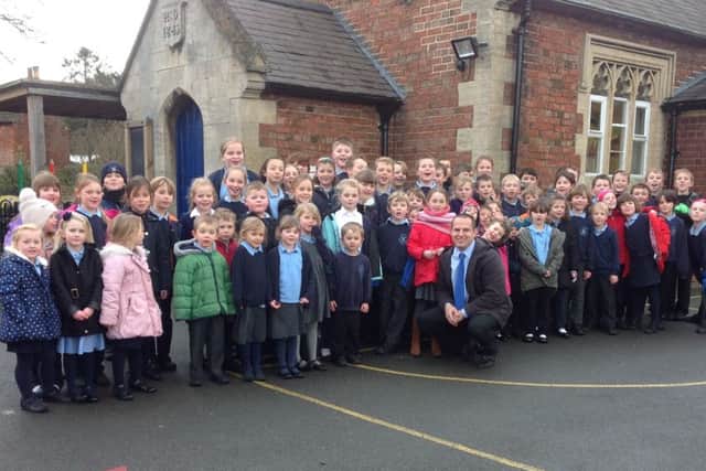 Headteacher Mr Matthew Lee with school pupils EMN-161201-165717001
